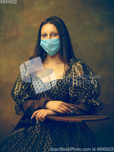 Image of Young woman as Mona Lisa on dark background. Retro style, comparison of eras concept.