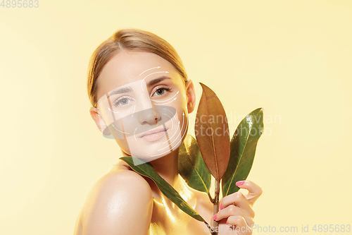 Image of Youth secrets. Beautiful young woman over white background. Cosmetics and makeup, lifting and aging concept.