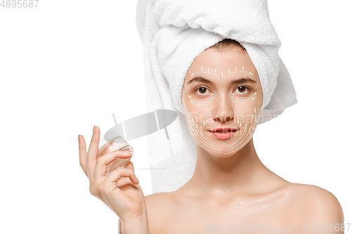 Image of Youth secrets. Beautiful young woman over white background. Cosmetics and makeup, lifting and aging concept.