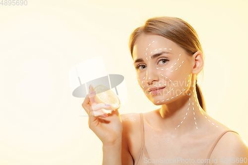 Image of Youth secrets. Beautiful young woman over white background. Cosmetics and makeup, lifting and aging concept.