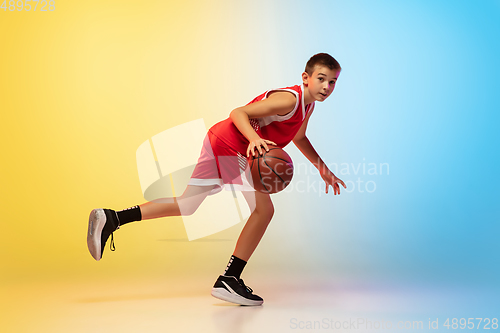 Image of Full length portrait of a young basketball player with ball on gradient background