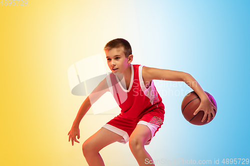 Image of Full length portrait of a young basketball player with ball on gradient background