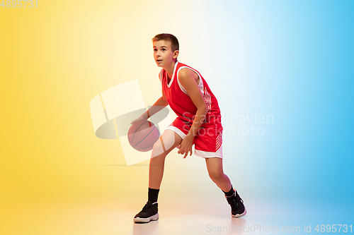 Image of Full length portrait of a young basketball player with ball on gradient background