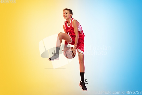 Image of Full length portrait of a young basketball player with ball on gradient background