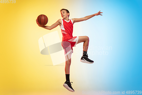 Image of Full length portrait of a young basketball player with ball on gradient background