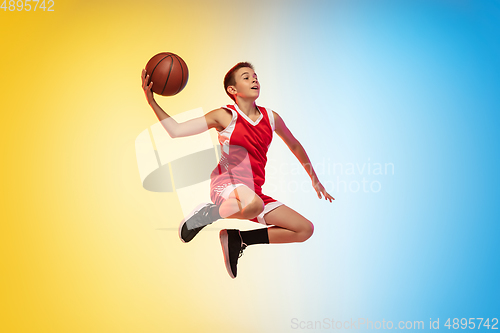 Image of Full length portrait of a young basketball player with ball on gradient background