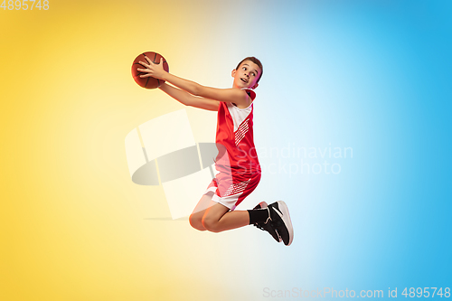 Image of Full length portrait of a young basketball player with ball on gradient background