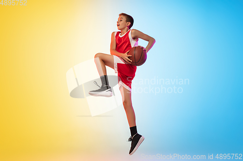 Image of Full length portrait of a young basketball player with ball on gradient background