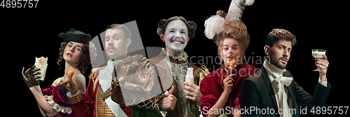 Image of Collage on young people in medieval attire on dark background. Retro style, comparison of eras concept.