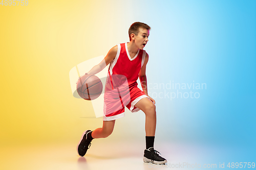 Image of Full length portrait of a young basketball player with ball on gradient background