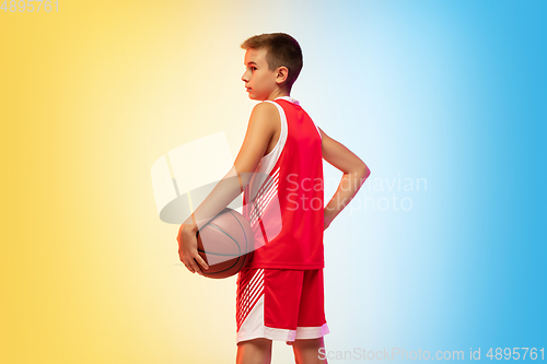 Image of Full length portrait of a young basketball player with ball on gradient background