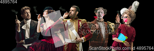 Image of Collage on young people in medieval attire on dark background. Retro style, comparison of eras concept.