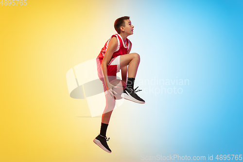 Image of Full length portrait of a young basketball player with ball on gradient background