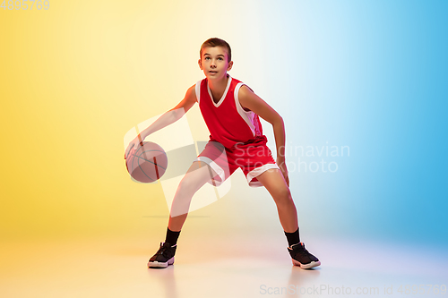 Image of Full length portrait of a young basketball player with ball on gradient background