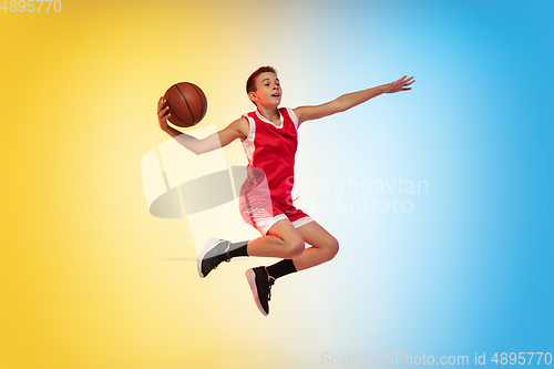 Image of Full length portrait of a young basketball player with ball on gradient background