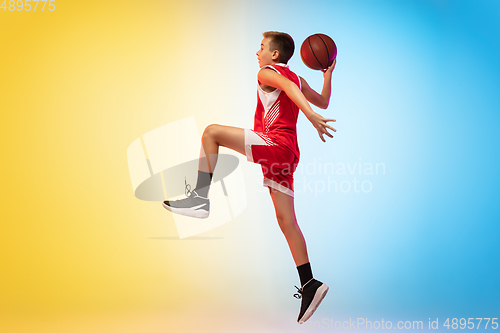 Image of Full length portrait of a young basketball player with ball on gradient background