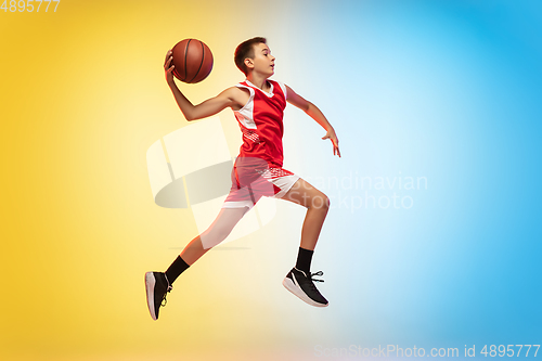 Image of Full length portrait of a young basketball player with ball on gradient background