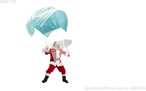 Image of Santa Claus flying on huge face mask like on balloon isolated on white background