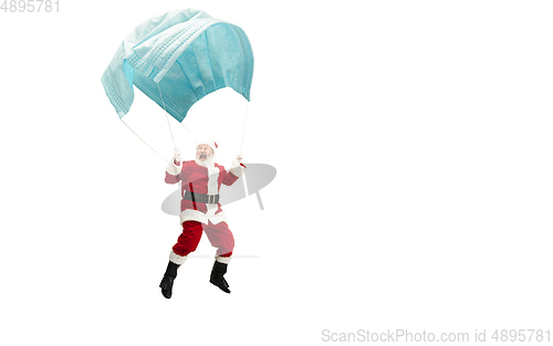 Image of Santa Claus flying on huge face mask like on balloon isolated on white background