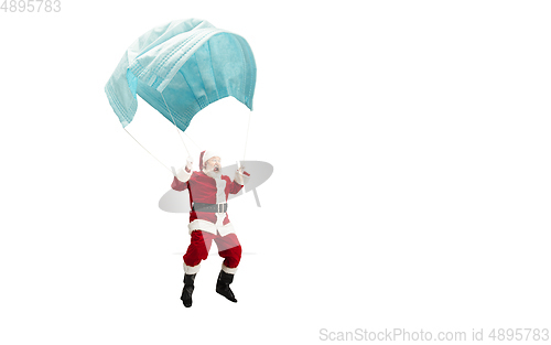 Image of Santa Claus flying on huge face mask like on balloon isolated on white background