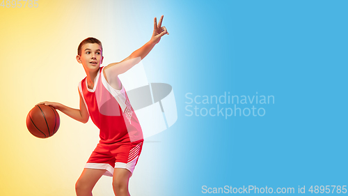 Image of Full length portrait of a young basketball player with ball on gradient background