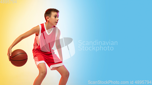 Image of Full length portrait of a young basketball player with ball on gradient background