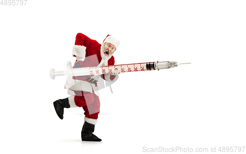 Image of Santa Claus holding huge vaccine against COVID like Christmas gift isolated on white background