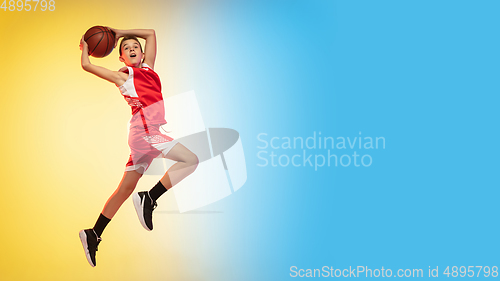 Image of Full length portrait of a young basketball player with ball on gradient background