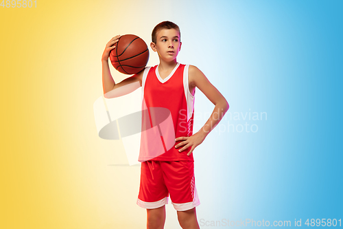 Image of Full length portrait of a young basketball player with ball on gradient background