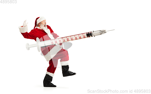 Image of Santa Claus holding huge vaccine against COVID like Christmas gift isolated on white background