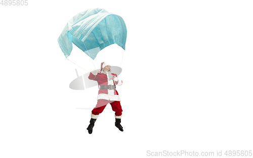 Image of Santa Claus flying on huge face mask like on balloon isolated on white background
