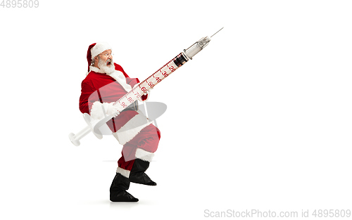 Image of Santa Claus holding huge vaccine against COVID like Christmas gift isolated on white background