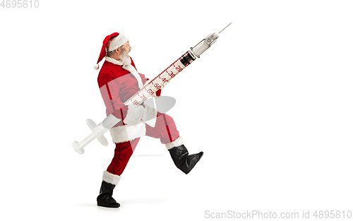 Image of Santa Claus holding huge vaccine against COVID like Christmas gift isolated on white background