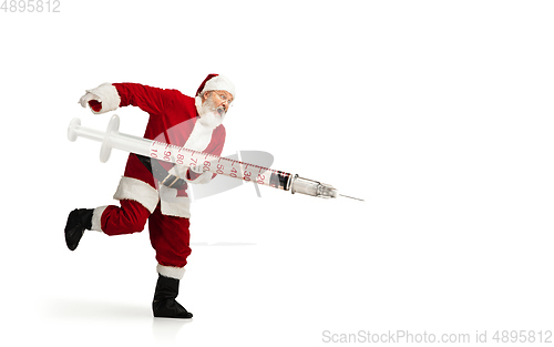 Image of Santa Claus holding huge vaccine against COVID like Christmas gift isolated on white background