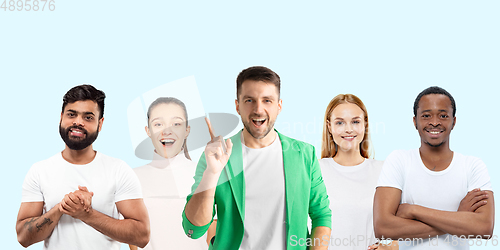 Image of Group portrait of emotional people on blue studio background