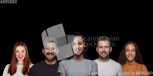 Image of Group portrait of emotional people on black studio background