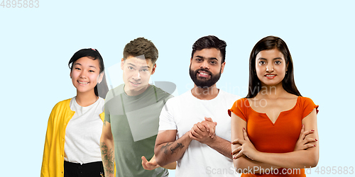 Image of Group portrait of emotional people on blue studio background