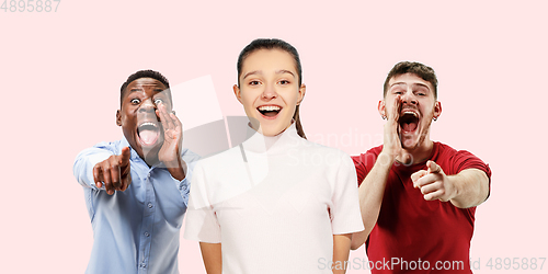 Image of Group portrait of emotional people on coral pink studio background