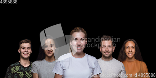 Image of Group portrait of emotional people on black studio background