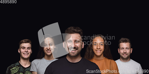 Image of Group portrait of emotional people on black studio background