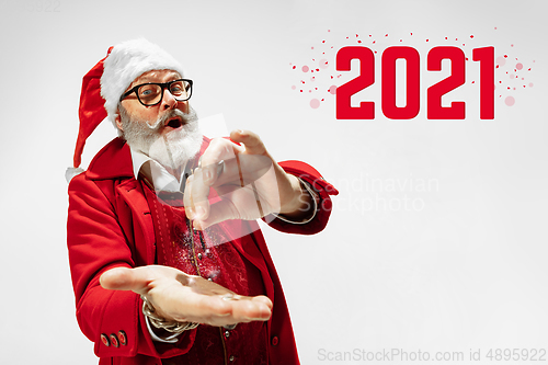 Image of Emotional Santa Claus in eyewear greeting with New Year 2021 and Christmas. Copyspace