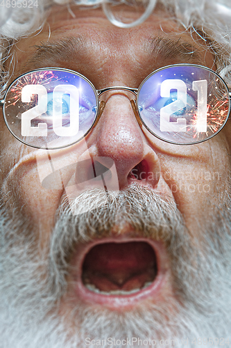 Image of Close up Santa Claus in glasses with a reflection of 2021 Happy New Year