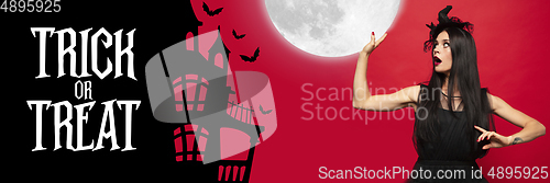 Image of Young woman in hat as a witch on scary red background