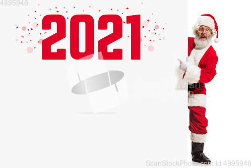 Image of Emotional Santa Claus in eyewear greeting with New Year 2021 and Christmas. Copyspace