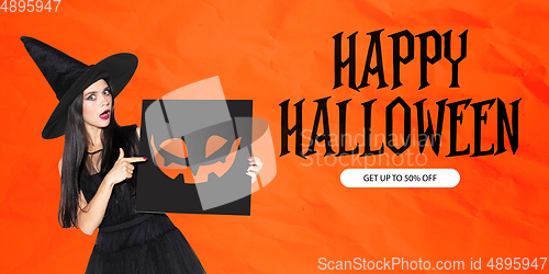 Image of Young woman in hat as a witch on scary orange background