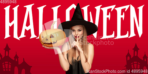 Image of Young woman in hat as a witch on scary red background