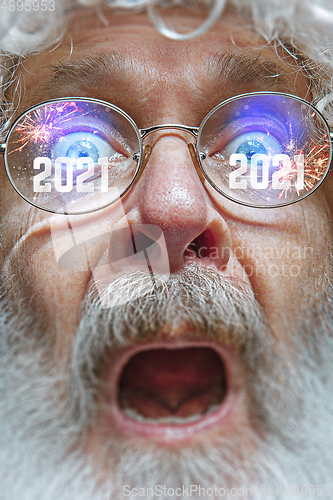 Image of Close up Santa Claus in glasses with a reflection of 2021 Happy New Year