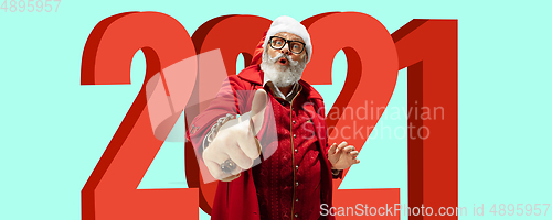 Image of Emotional Santa Claus in eyewear greeting with New Year 2021 and Christmas. Copyspace