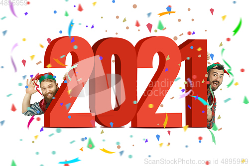Image of Happy Christmas Santa Clause\'s elfs with huge 2021 lettering isolated on white