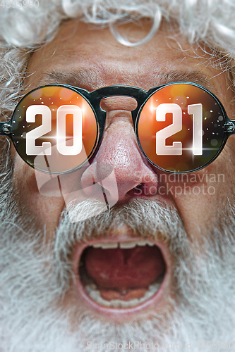 Image of Close up Santa Claus in glasses with a reflection of 2021 Happy New Year